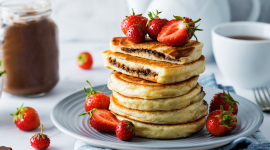 Pancakes with strawberries, basil and chocolate